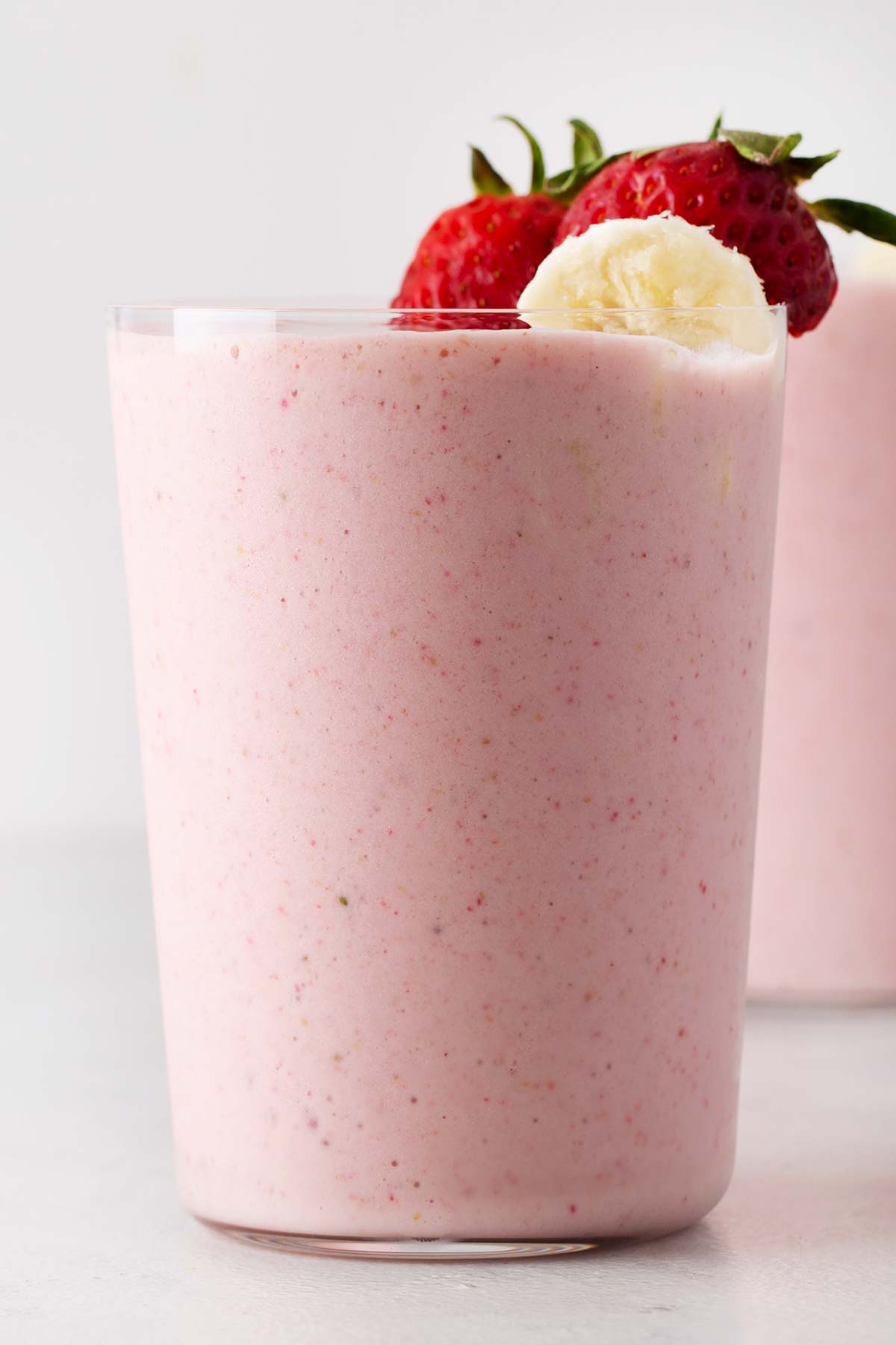 Strawberry banana smoothie in a cup.