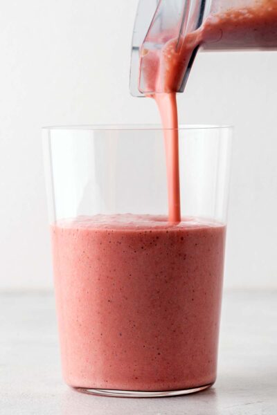 Strawberry banana smoothie poured into a cup. 