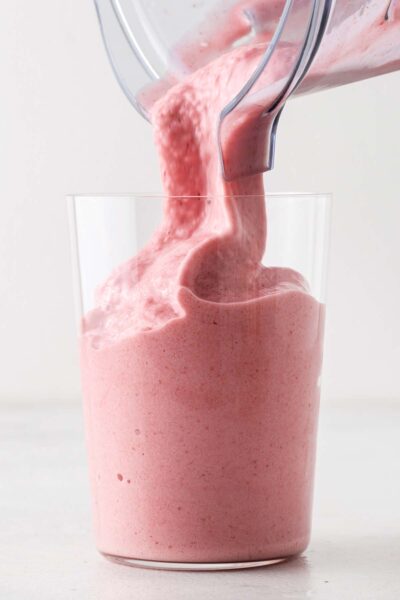 Strawberry smoothie poured in a cup. 