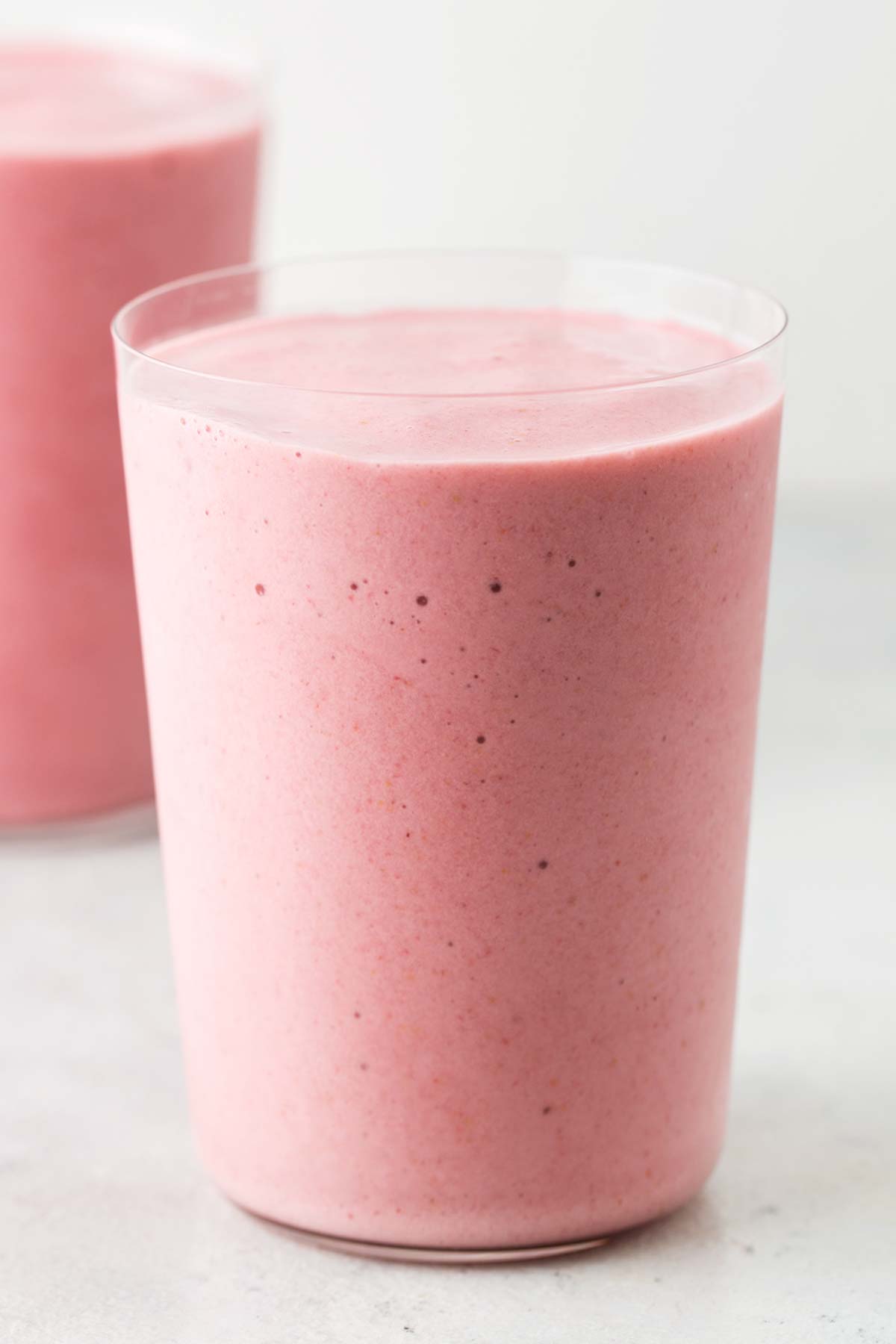 Strawberry collagen smoothie in a glass.
