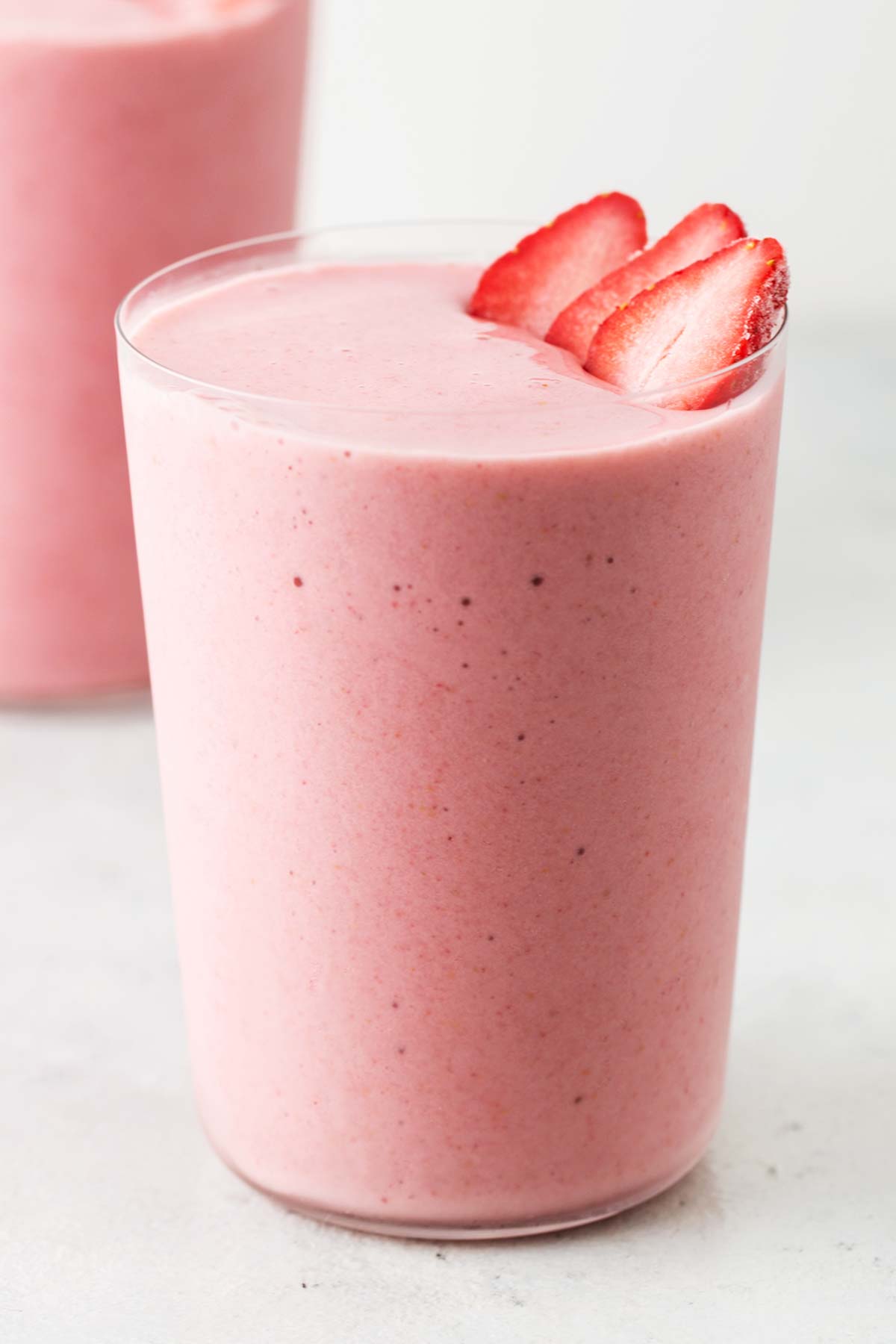 Strawberry collagen smoothie in a glass.