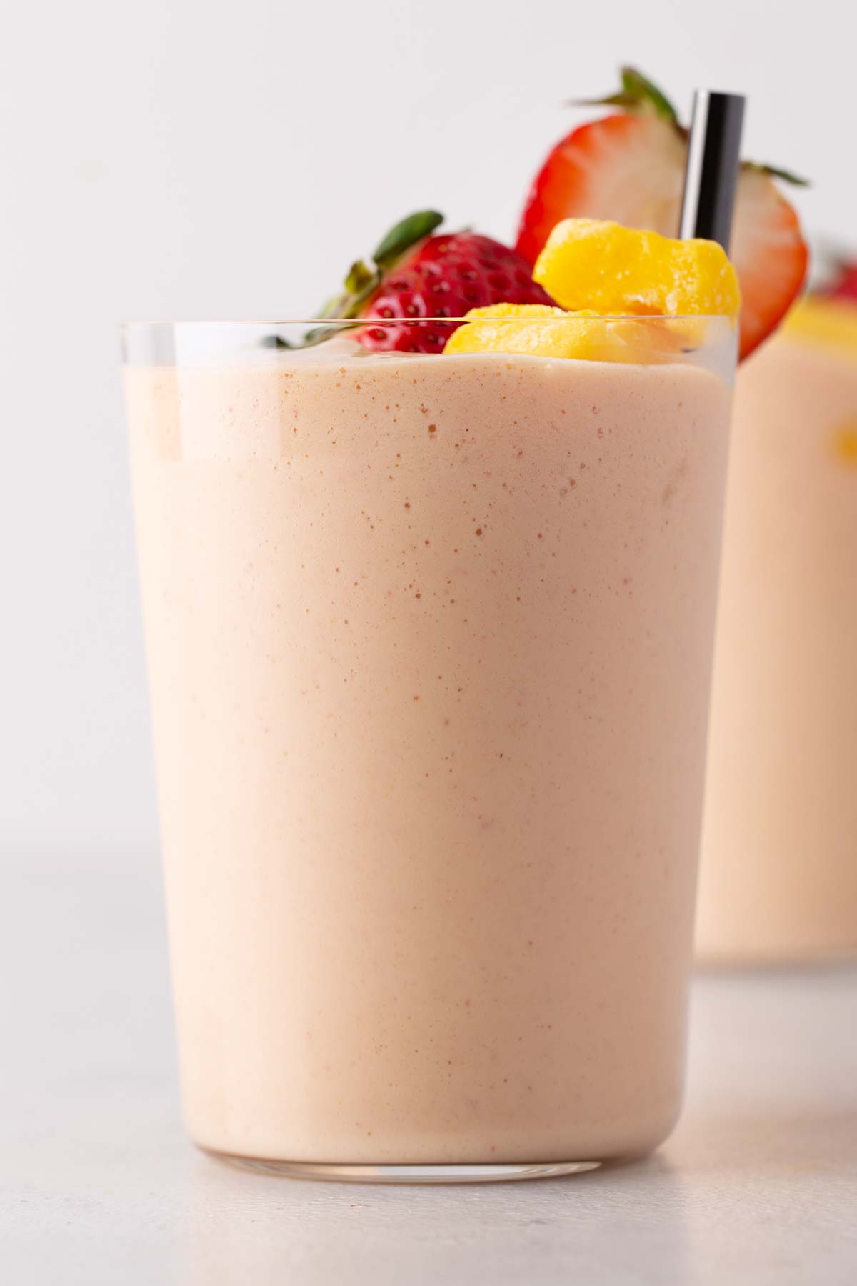 Strawberry mango smoothie in a glass.