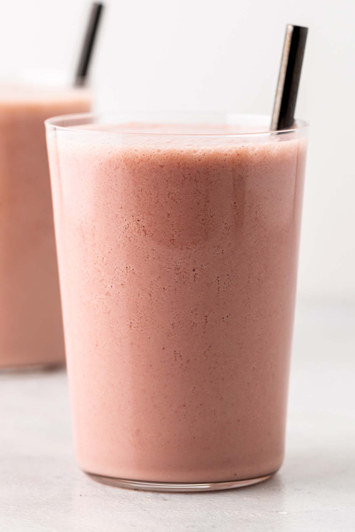 Strawberry protein shake in a cup.