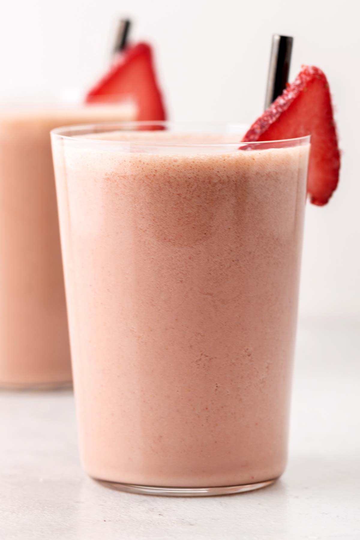 Strawberry protein shake in a glass.