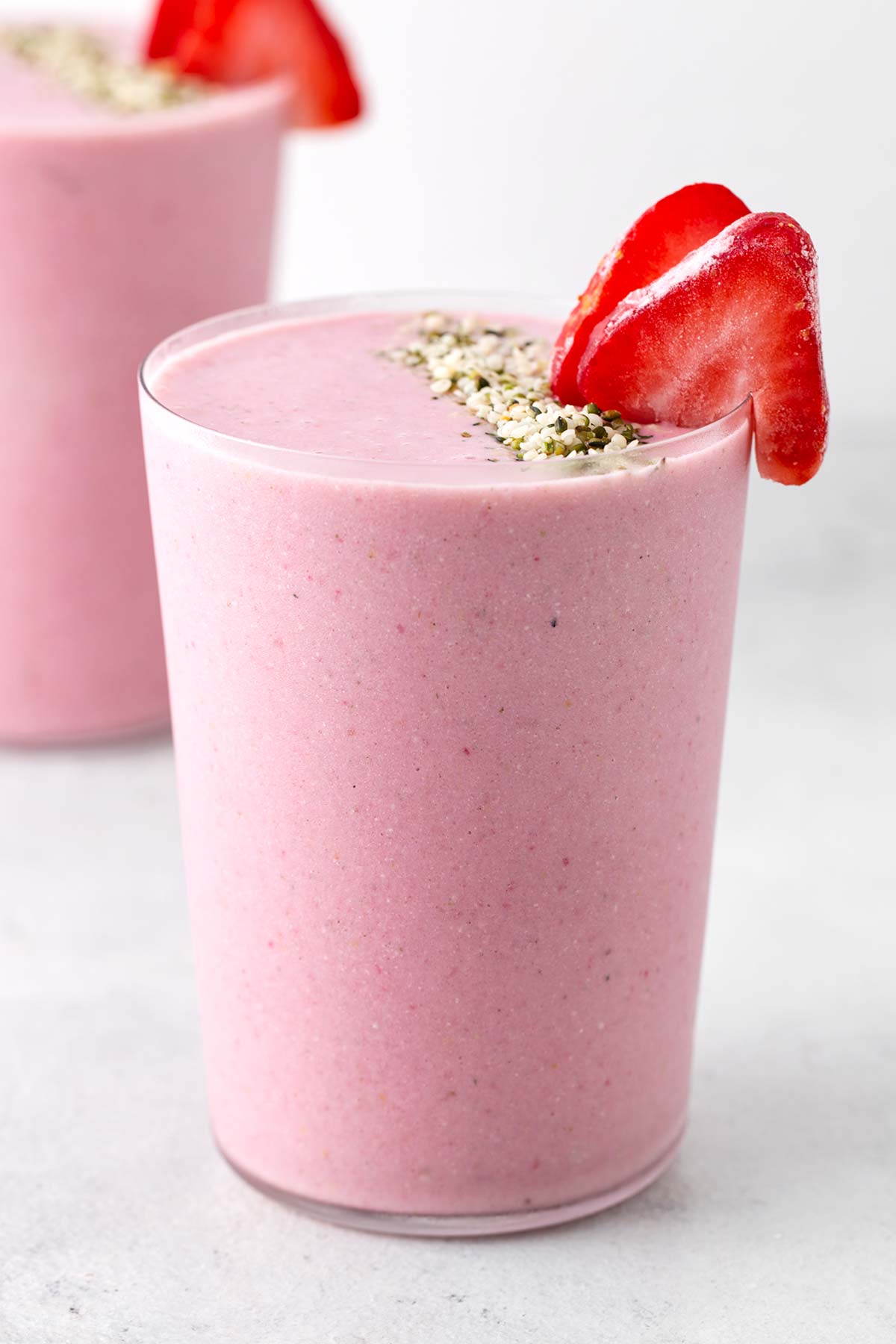 Strawberry protein smoothie in a glass.