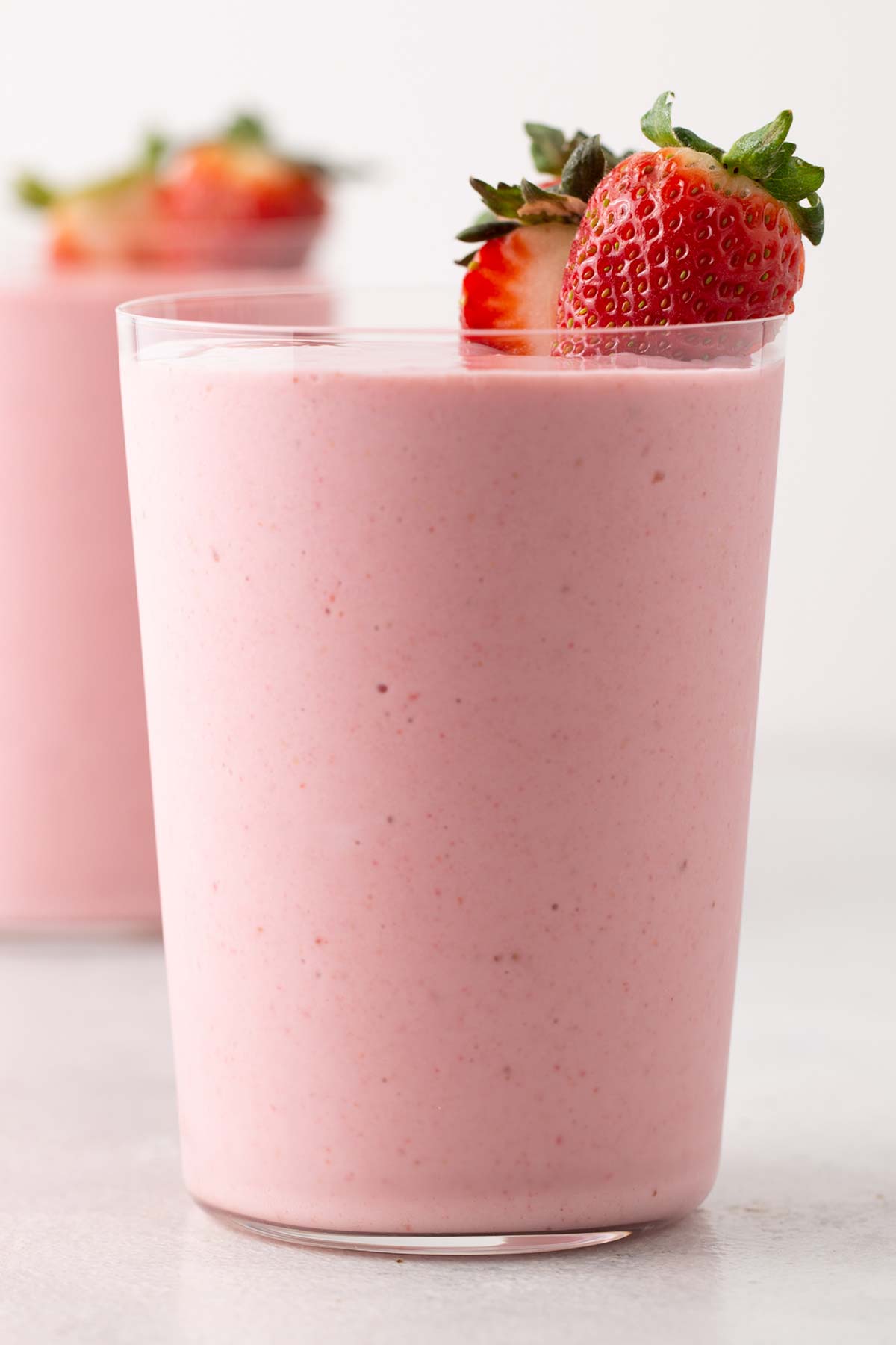 Strawberry smoothie in a glass cup.