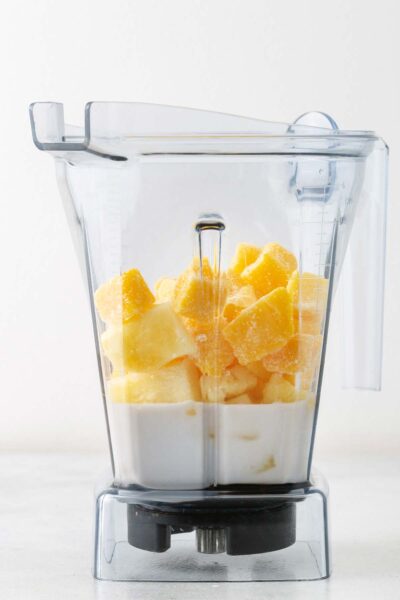 Mango, pineapple, date syrup and coconut milk in a blender. 