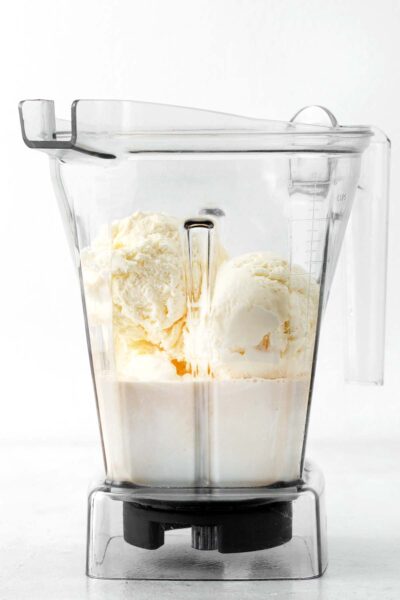 Milk and vanilla ice cream in a blender.